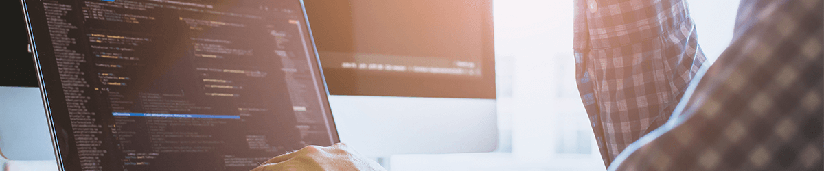 Close-up of an adult technology user working on a computer with a human hand on the internet.